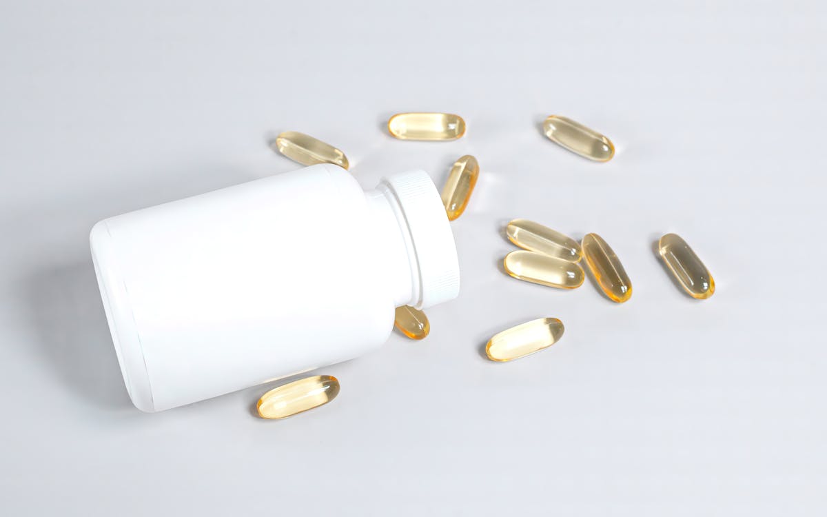 supplement capsules spilled from bottle